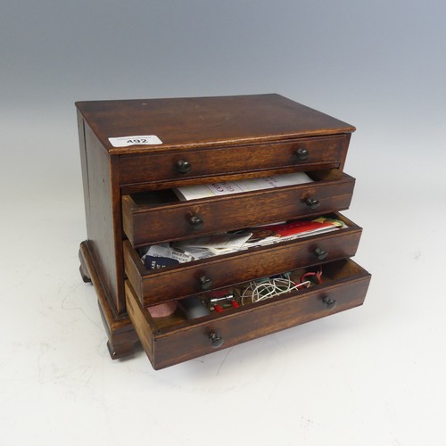 492 - An antique oak miniature tabletop Chest of drawers, rectangular top over four long graduating drawer... 