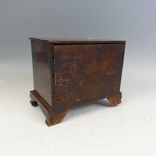 492 - An antique oak miniature tabletop Chest of drawers, rectangular top over four long graduating drawer... 