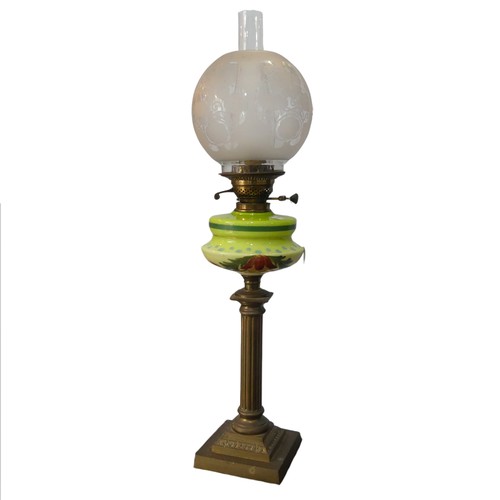 526 - An antique brass corinthian column Oil Lamp, painted Bohemian style glass reservoir, stamped 'Britis... 