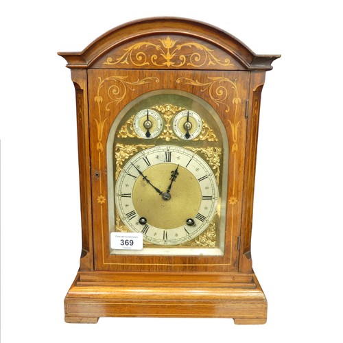 369 - A London Camerer Kuss & Co marquetry inlaid mantel Clock, the arched brass dial with foliate scr... 