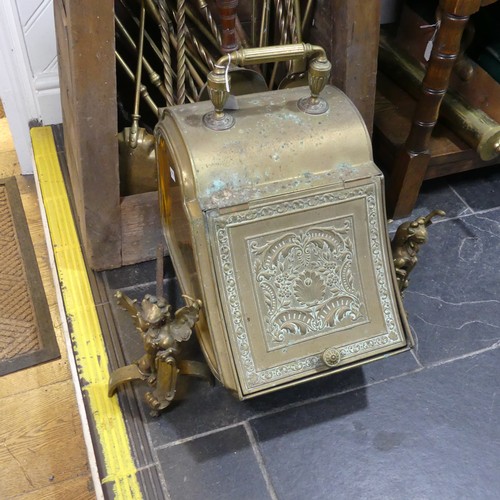 690 - An antique brass coal Scuttle, together with a pair of antique brass firedogs in the form of winged ... 