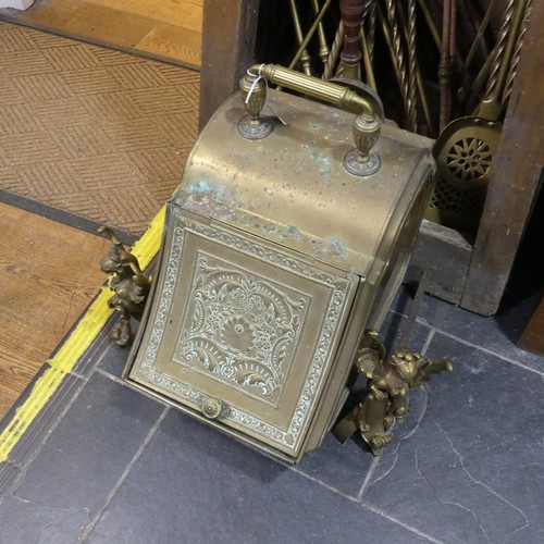 690 - An antique brass coal Scuttle, together with a pair of antique brass firedogs in the form of winged ... 