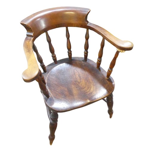 595 - A 19th century elm and ash smokers bow / captains Chair, horseshoe bar back above scroll arms and sh... 