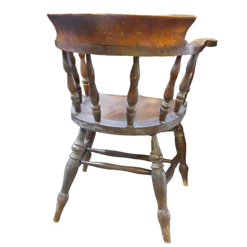 595 - A 19th century elm and ash smokers bow / captains Chair, horseshoe bar back above scroll arms and sh... 