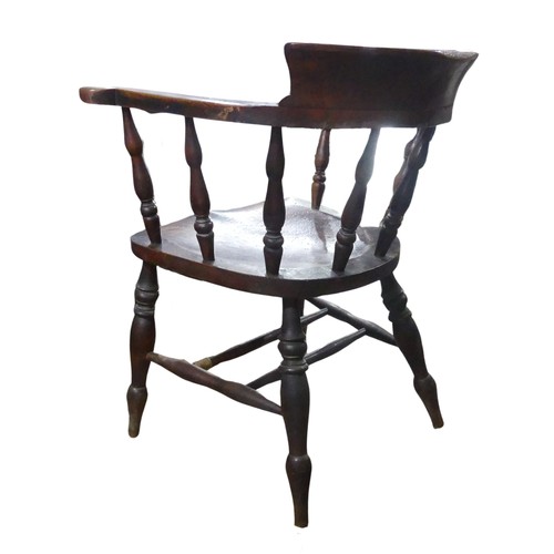 568 - A 19th century elm and ash smokers bow / captains Chair, horseshoe bar back above scroll arms and sh... 