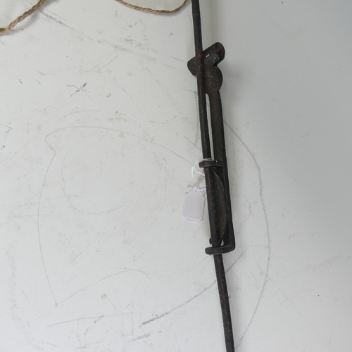 677 - An 18thC wrought iron wall Rush Light, with height adjuster, L 71.5 cm.