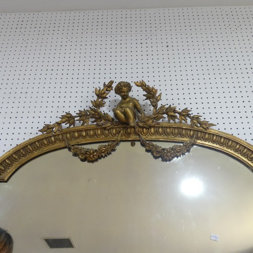 506 - A 19th century large gilt framed wall Mirror, central pediment depicting a carved Putti, scrolled le... 