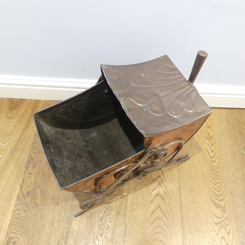 499 - An Arts and Crafts copper Coal Scuttle, in the manner of Christopher Dresser, with swing handle and ... 