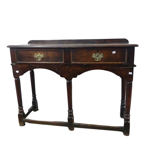 696 - An 18th century oak hall Table, moulded top with rail back, above two frieze drawers, raised on five... 