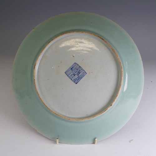 4 - A matched pair of 19thC Chinese celadon Chargers, typical colouration with central depiction of orna... 