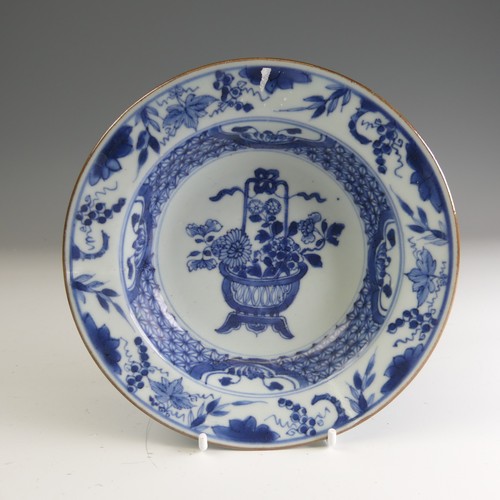 21 - A near pair of 18thC Chinese blue and white porcelain Chargers, each decorated centrally with floral... 