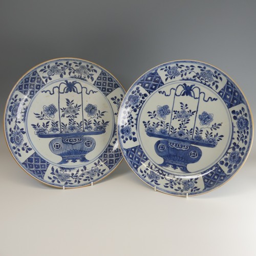 21 - A near pair of 18thC Chinese blue and white porcelain Chargers, each decorated centrally with floral... 