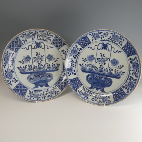 21 - A near pair of 18thC Chinese blue and white porcelain Chargers, each decorated centrally with floral... 