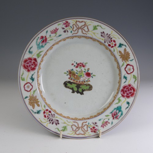 24 - An 18thC Chinese porcelain famille rose Charger, c. 1730, the well decorated with famille jaune bowl... 