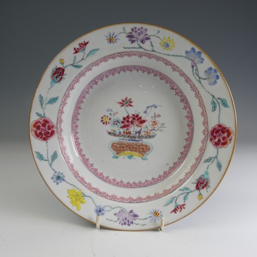 24 - An 18thC Chinese porcelain famille rose Charger, c. 1730, the well decorated with famille jaune bowl... 