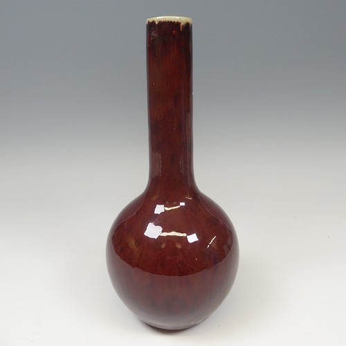 41 - A Chinese sang de beouf flambe Bottle Vase, with globular body and slender tapering neck, H 31.5cm.P... 