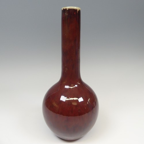 41 - A Chinese sang de beouf flambe Bottle Vase, with globular body and slender tapering neck, H 31.5cm.P... 