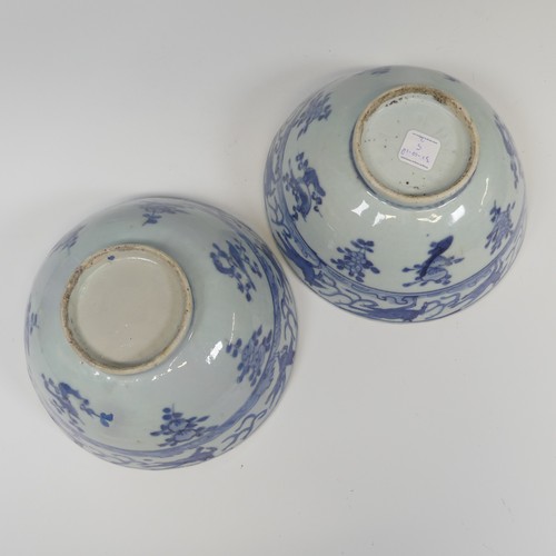 52 - A pair of antique Chinese blue and white Bowls, with underglaze bandes of decoration, raised on pott... 