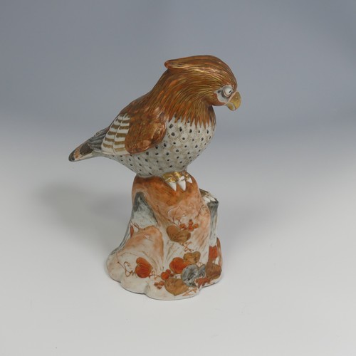 110 - A 19thC Japanese kutani porcelain sculpture of a Bird of Prey, decorated in the typical palette, six... 