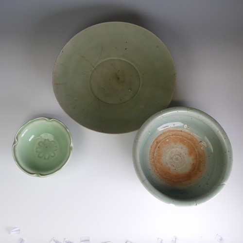 96 - A large antique Chinese celadon Charger, hairline cracks and firing fault to the foot, D 32cm, toget... 