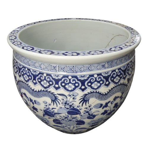 100 - A large decorative antique Chinese blue and white Jardiniere, decorated with dragons amongst chrysan... 