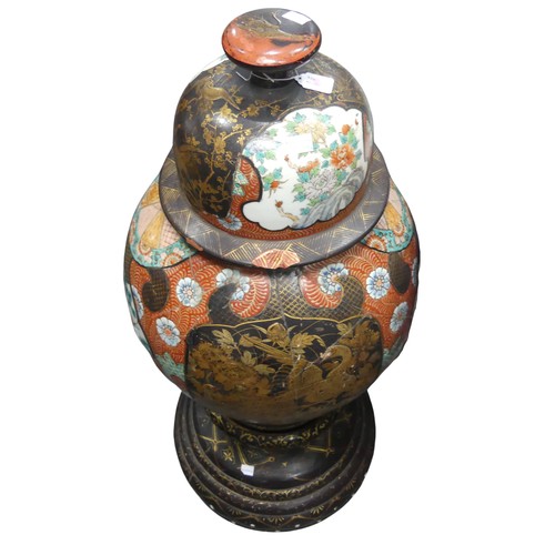 113 - A large decorative Japanese floor standing Temple Jar, decorated in reds, gilts and black lacquer en... 