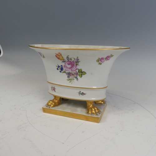 224 - A Herend hand painted porcelain oval Cachepot, painted with flowers and raised on gilt lion claw fee... 