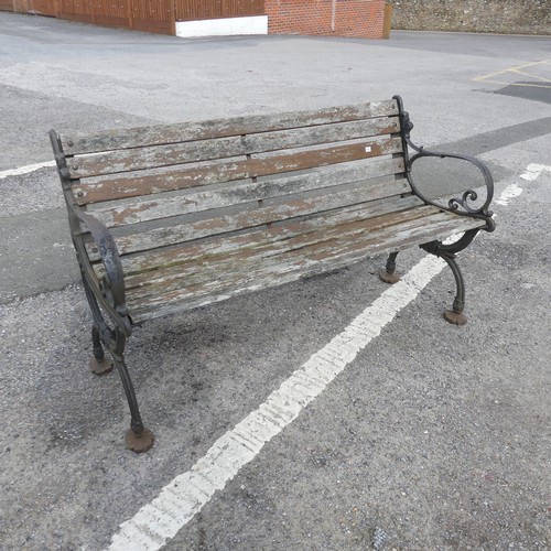 353 - An antique cast iron and teak Garden Seat /Bench, with scrolled supports, W 129.5 cm x H 74 cm x D 4... 