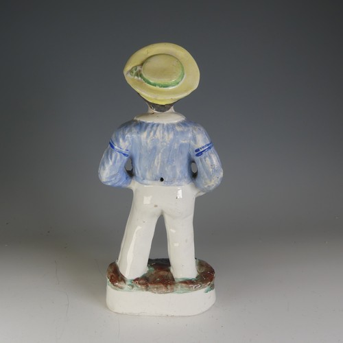 233 - A 19thC Staffordshire pottery figure of a Sailor, decorated in polychromes, raised on gilt line plin... 