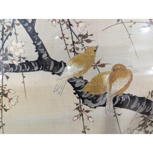 183 - A large early 20th century Japanese embroidered silk picture, depicting a branch with blossom and bi... 