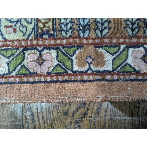 343 - Tribal Rugs; a finely hand-knotted Persian rug, wool and silk pile on cotton base, salmon pink groun... 