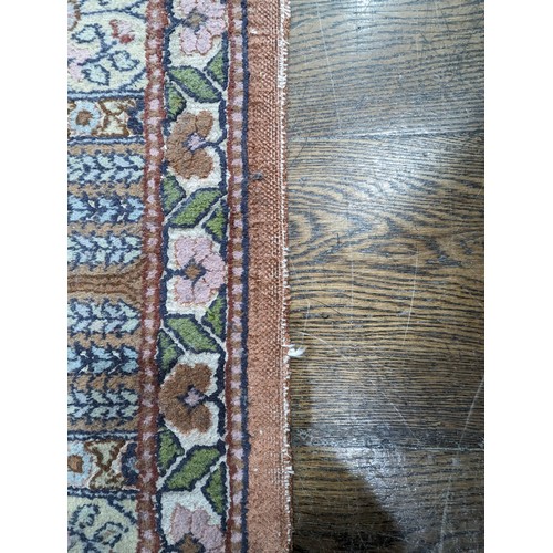 343 - Tribal Rugs; a finely hand-knotted Persian rug, wool and silk pile on cotton base, salmon pink groun... 