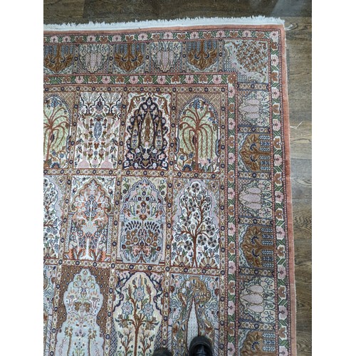 343 - Tribal Rugs; a finely hand-knotted Persian rug, wool and silk pile on cotton base, salmon pink groun... 