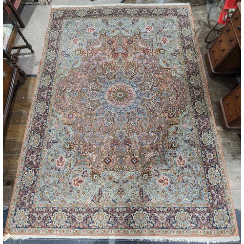 346 - Tribal Rugs; a finely hand-knotted Persian rug, wool and silk pile on cotton base, salmon pink groun... 