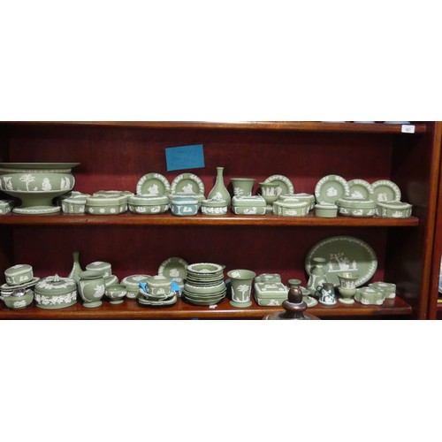 249 - A large quantity of Wedgwood green Jasperware, including pedestal bowl, trinket boxes, vases, etc., ... 