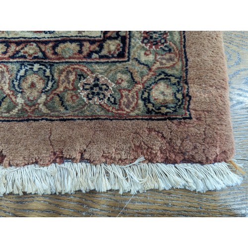 347 - Tribal Rugs; a fine hand-knotted Persian Isfahan rug, wool pile on cotton base, buff ground woven wi... 