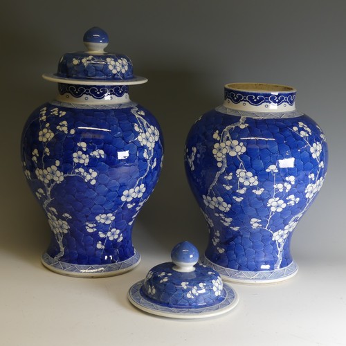 186 - A pair of early 20th century Chinese blue and white porcelain prunus Temple Jars, decorated in typic... 