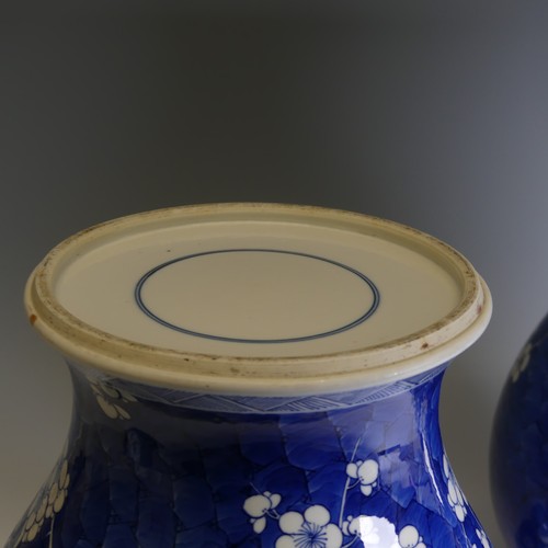 186 - A pair of early 20th century Chinese blue and white porcelain prunus Temple Jars, decorated in typic... 