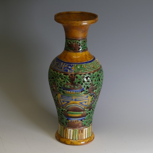 46 - A Chinese double walled reticulated Vase, of baluster form, in ochre ground with blue and green colo... 