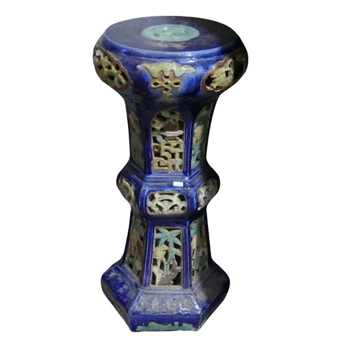 14 - A 20thC Chinese pottery Jardiniere Stand, with pierced apertures, decorated in blues and oranges, H ... 