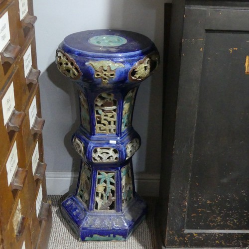 14 - A 20thC Chinese pottery Jardiniere Stand, with pierced apertures, decorated in blues and oranges, H ... 