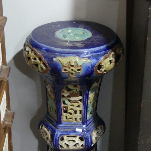 14 - A 20thC Chinese pottery Jardiniere Stand, with pierced apertures, decorated in blues and oranges, H ... 