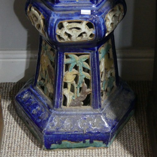 14 - A 20thC Chinese pottery Jardiniere Stand, with pierced apertures, decorated in blues and oranges, H ... 