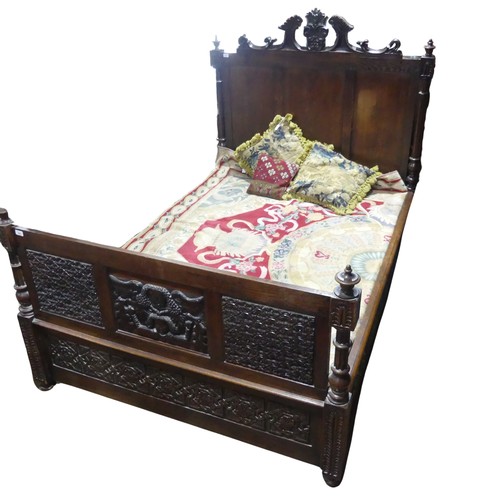 605 - An antique French Breton double Bed, with highly carved headboard and footboard, sideboards with pos... 