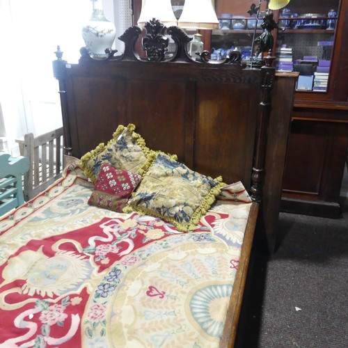 605 - An antique French Breton double Bed, with highly carved headboard and footboard, sideboards with pos... 