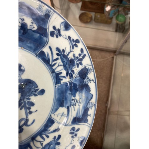 17 - A near pair of early 18thC Chinese porcelain blue and white Plates, the well decorated with flower b... 