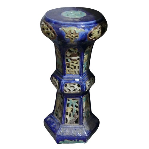 357 - A 20thC Chinese pottery Jardiniere Stand, with pierced apertures, decorated in blues and oranges, H ... 