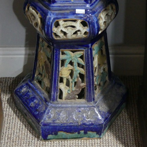 357 - A 20thC Chinese pottery Jardiniere Stand, with pierced apertures, decorated in blues and oranges, H ... 