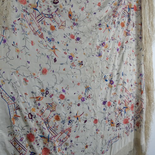 306 - An early 20th century silk embroidered Cantonese Piano Shawl, the cream ground with exotic birds and... 