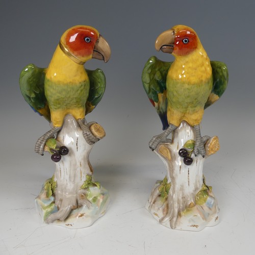A pair of 20thC continental porcelain Parrots, modelled perched on a tree, underglaze blue mark to base, one damaged, H 31cm (2)